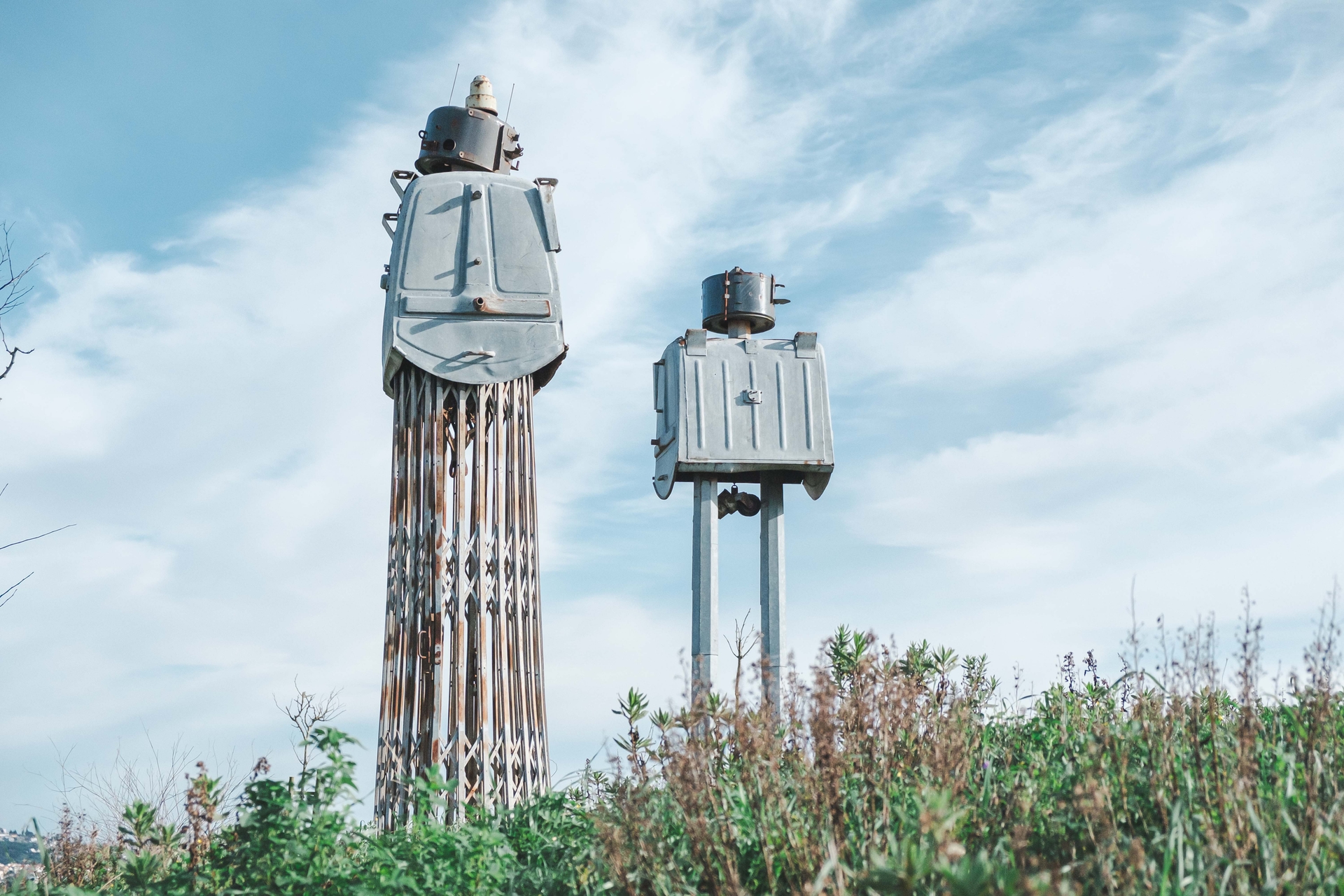 sculpture of two robots in a field