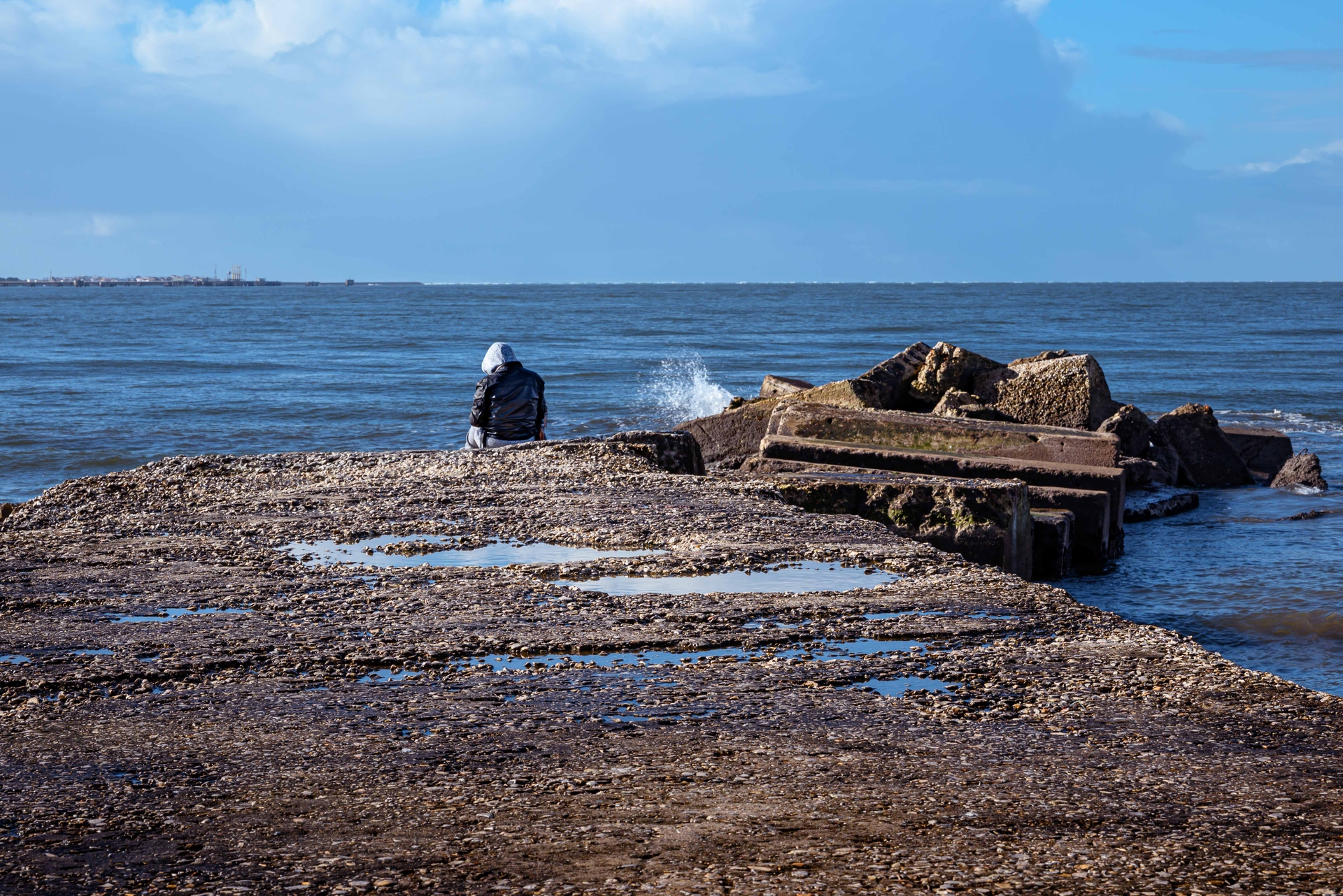 person sit in a pier